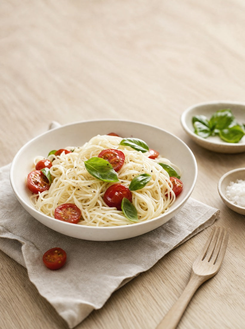 A bright lunch bowl of egg white spaghetti with tomatoes and basil