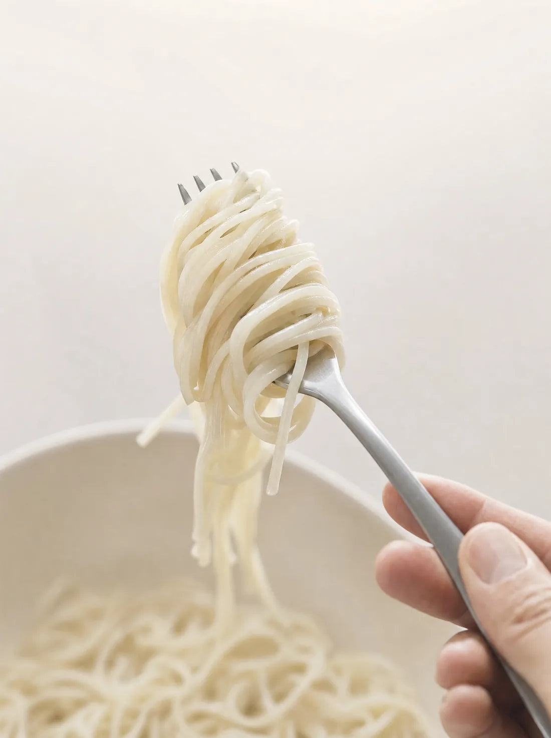 Lifting a forkful of egg white spaghetti