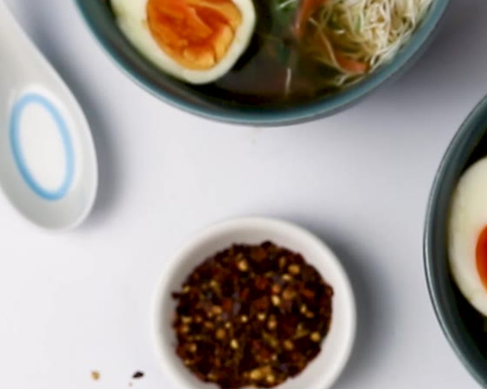 Ramen noodles heating in a bowl