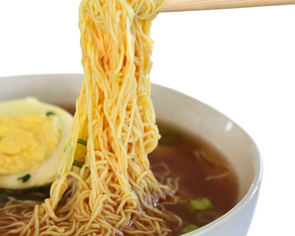 Stirring the Korean ramen seasoning into the hot noodles